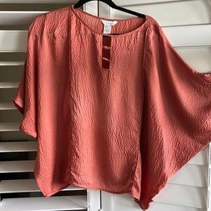 Sundance 💯 % pounded silk blouse. The color is a very saturated rust/ginger.